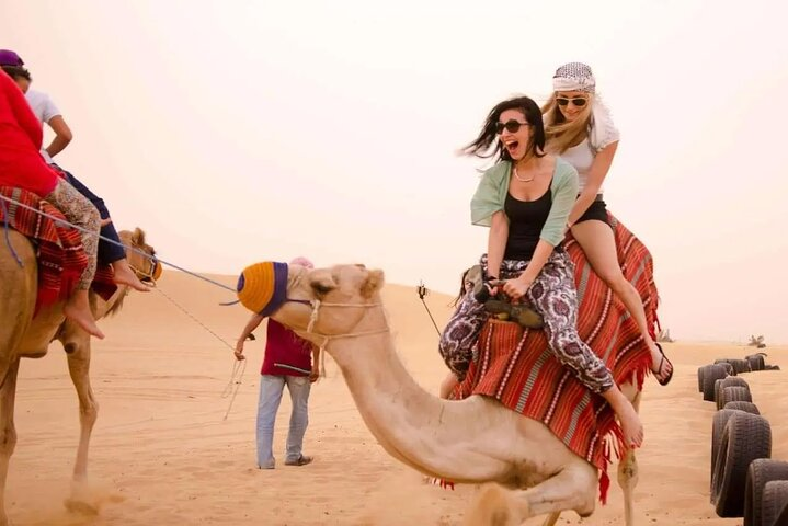 Embark on a camel ride across golden sands surrounded by the serene desert landscape capturing unforgettable moments before continuing your adventure at the iconic Burj Khalifa.